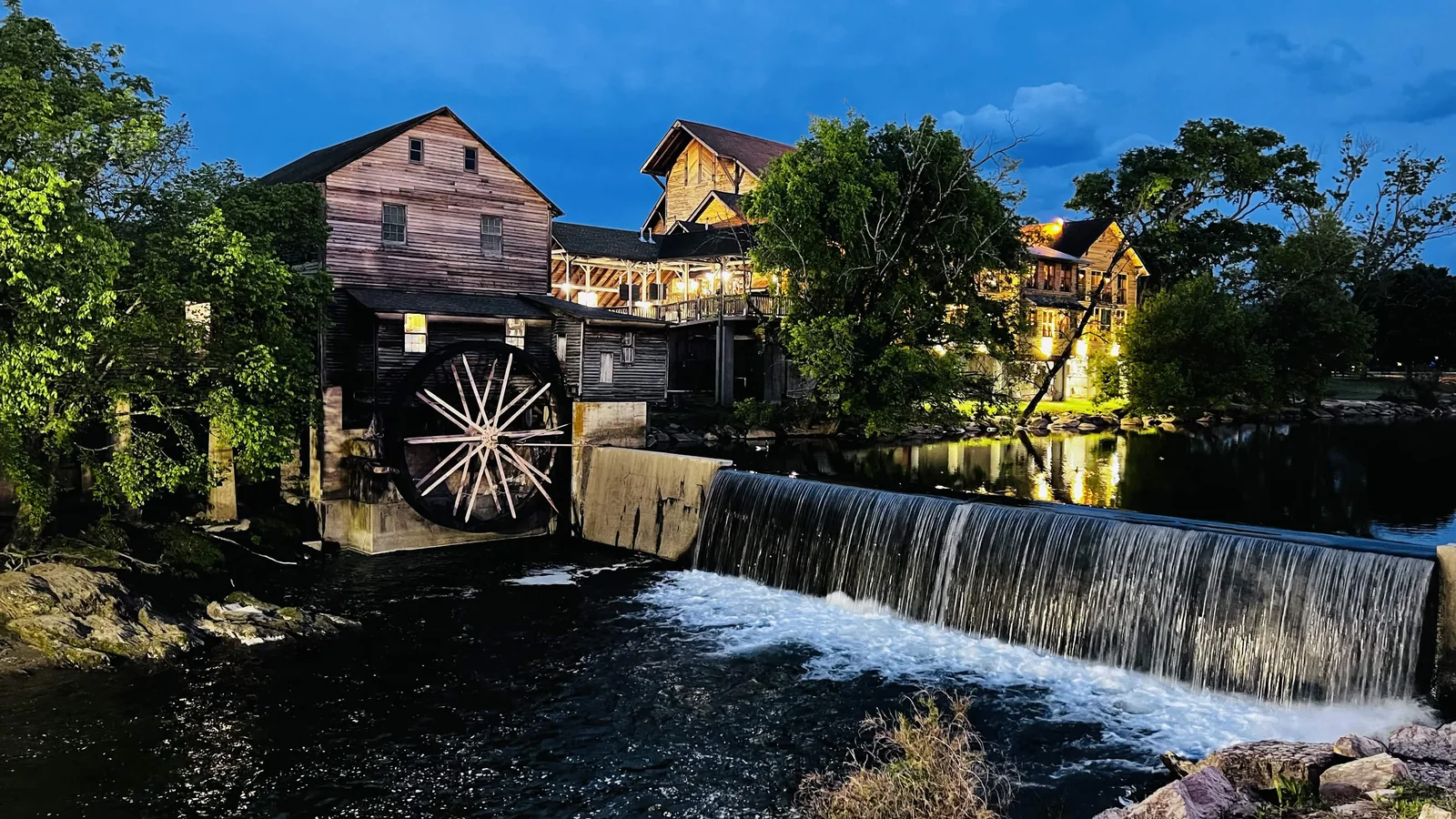 Old mill and waterfall lit at night